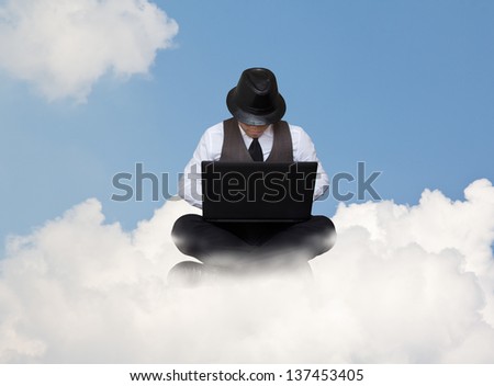 Businessman working with laptop on a cloud.