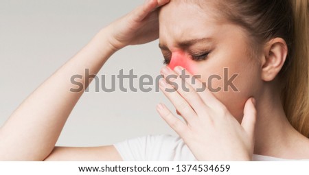 Young woman tired, rubbing nose and eyes, feeling fatigue and headache, black and white photo with red inflamed zone