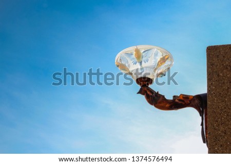 Light bulb from fairy lights during sunset by the beach in Thailand 