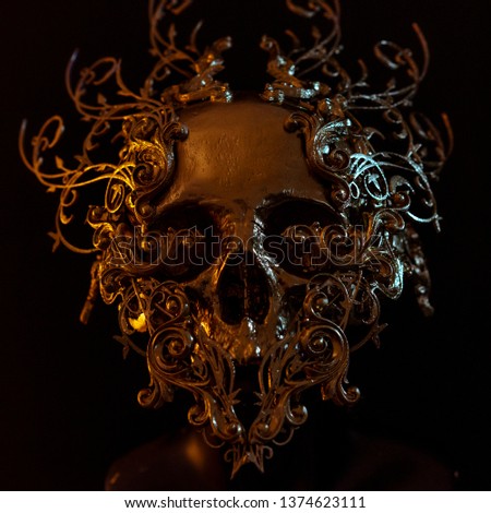 golden skull made with 3d printer and pieces by hand. Gothic piece of decoration for halloween or horror scenes