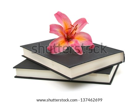 still life with huge bunch of spring lily and black book isolated on white background