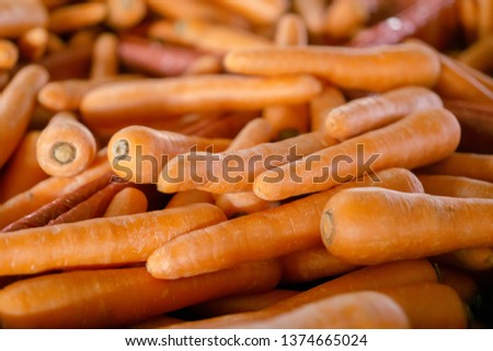 Pile of orange colored carrots for sale in a market.