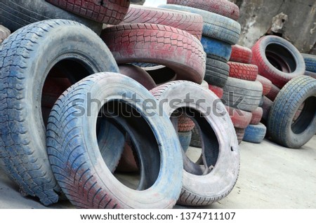 A picture of many old used tires left on a waste dump