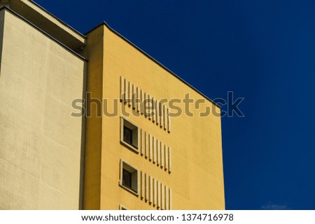 Yellow building corner blue sky