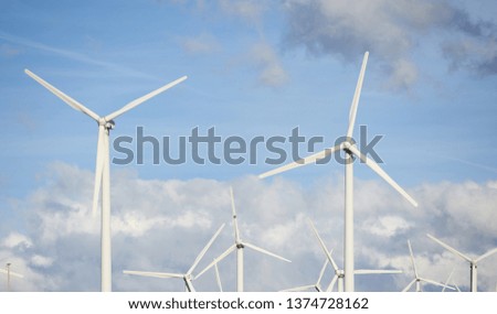 Photo of a wind farm on blue sky