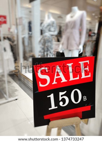 Red​ sale​ advertisement​ discount​ in​ front​ of​ the​ shop​ at​ department​ store.​ 