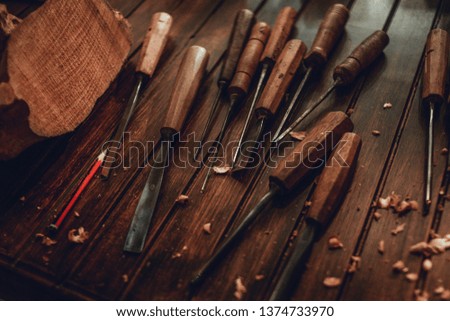 Woodworking and crafts tools. Carpentry hand tools on a workbench. Chisels, measuring tools. Wooden parts, planks and stocks. Wooden background.