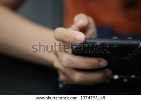 Woman enjoy with mobile game in hands