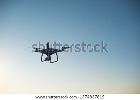 White drone fly in the sky recording a video
