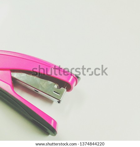 Pink stapler isolated on a white background
