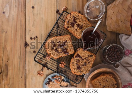 Cake with cocoa and chocolate on a wooden table. Sweet homemade pastries for breakfast. Rustic style photo