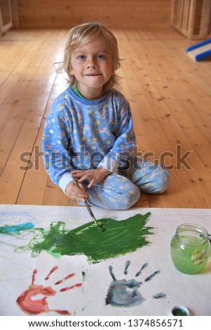Boy, drawing a picture for father's day. Portrait of cute little boy drawing with brush. Creativity with children. The child learns to draw.