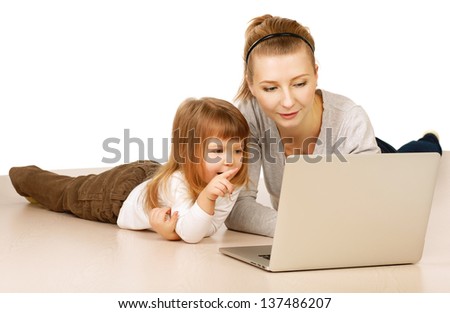 mother and child with laptop computer lying on the floor, isolated on white background