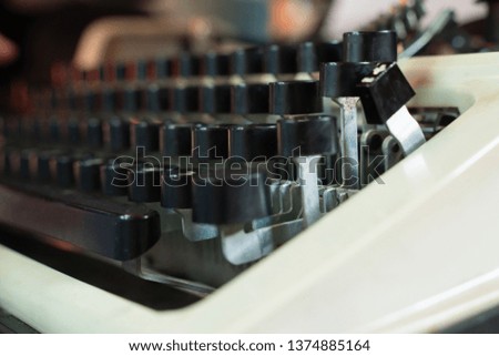 keyboard of old typewriter with black keys close up as background. Design and retro style.