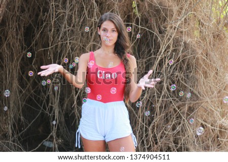 happy beautiful woman blowing soap bubbles outdoor smiling. Happy