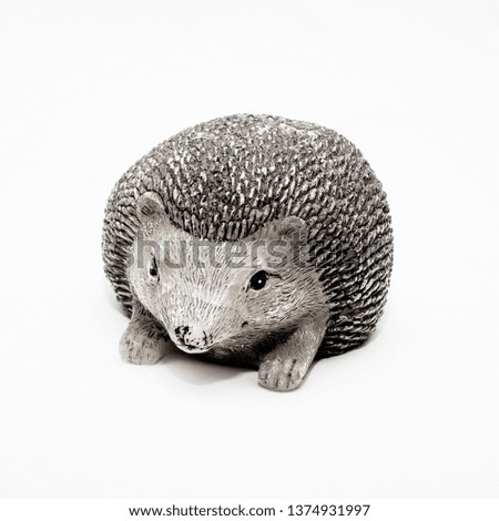 Image shows a picture of a hedgehog statue set against a white background.