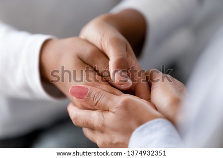 Close up caring African American mother holding child hands, showing love and support, black mum comforting, caressing kid, children protection concept, family enjoying moment together Royalty-Free Stock Photo #1374932351