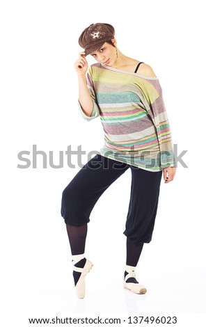 Modern female ballet dancer with black pants and a colorful striped jersey and cap en pointe on a white background in various ballet positions.