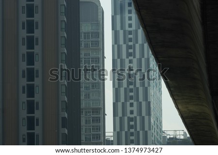 Condo window pattern and overpass toll way on sky background