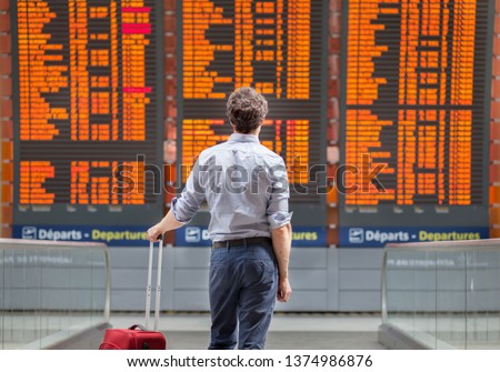 travel with international flight, person passenger waiting in airport departure terminal Royalty-Free Stock Photo #1374986876