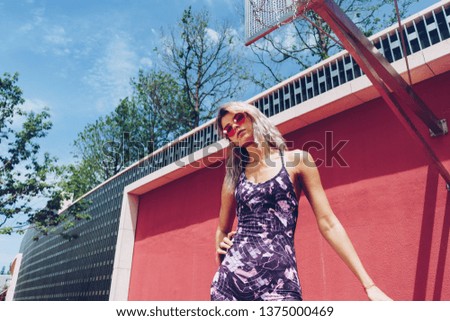 Athletic hipster girl standing on the basketball court