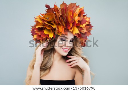 Beautiful model portrait. Autumn woman in colorful maple leaves crown