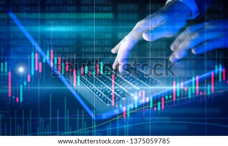 Businessman is using laptop and analysing the financial data at his office. Concept of a digital diagram, graph interface, virtual screen, technical price indicator, trading online, global market