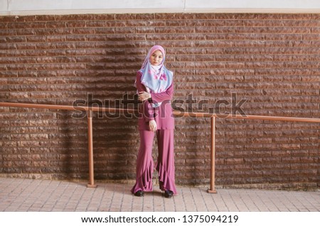 Arabian woman with happy smile. Strict formal outfit and elegant appearance. Islamic fashion.