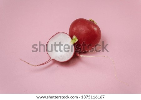 Beautiful red radish on a pink background, razreny red radish on a pink background, composition with red radish