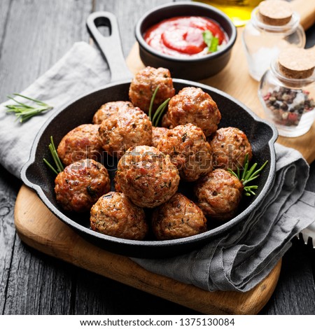 Meatballs served with tomato sauce in frying pan . Royalty-Free Stock Photo #1375130084