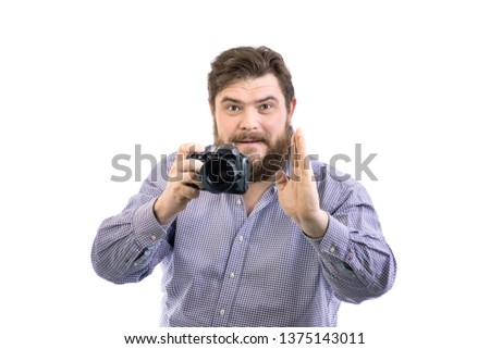 portrait of serious big handsome bearded photographer posing with professional DSLR camera, isolated on white background