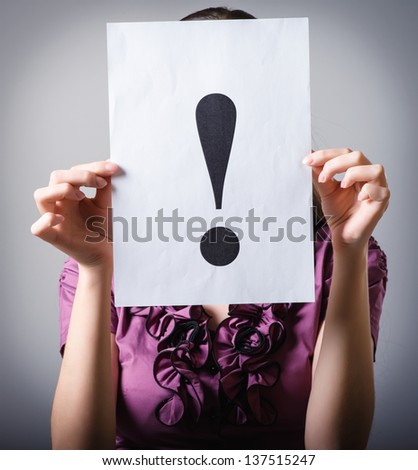Girl holds exclamation mark