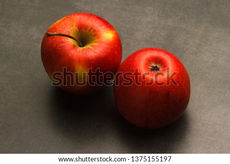 two red apples on grey stone background