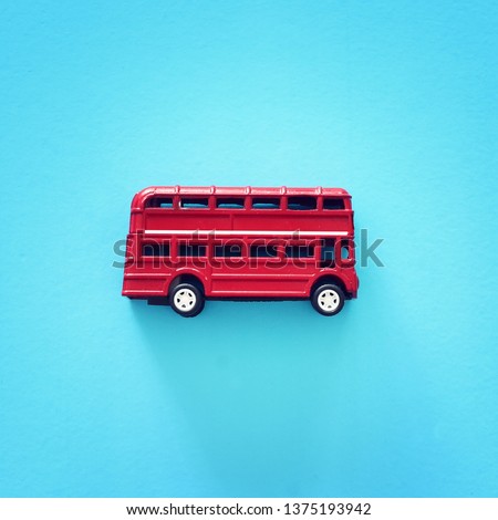 London traditional red double decker bus over blue background.