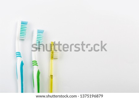 New different colored toothbrushes on a white background