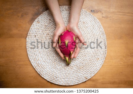 Female hand with dragon fruit