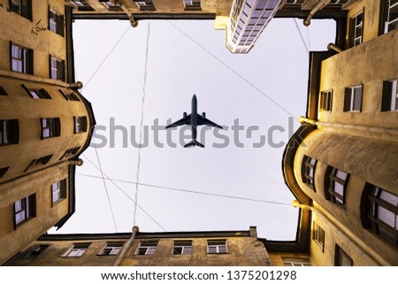 House well. The aircraft, the plane flies over the house. Old town house. Bottom view. Royalty-Free Stock Photo #1375201298