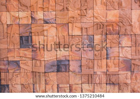 Walls of buildings made of clay tiles that are various images that convey meaning as background images.