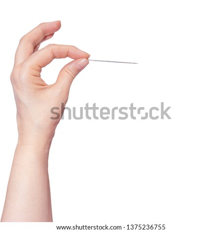 Woman's hand holding a needle on white background. Royalty-Free Stock Photo #1375236755
