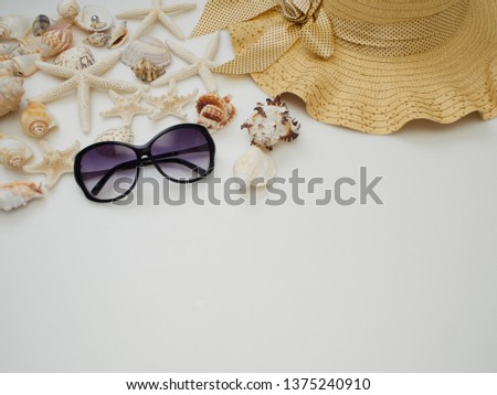 Summer beach dress items - shells, starfish, sunglasses, straw hats on a white background For pictures, travel, holidays and travel. Flat lay, top view