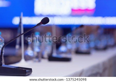 Front view of the microphones during business conference in conference room or hall, panel duscusion of economic development Royalty-Free Stock Photo #1375245098