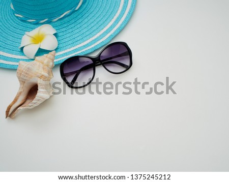 Summer beach dress items - shells, starfish, sunglasses, straw hats on a white background For pictures, travel, holidays and travel. Flat lay, top view