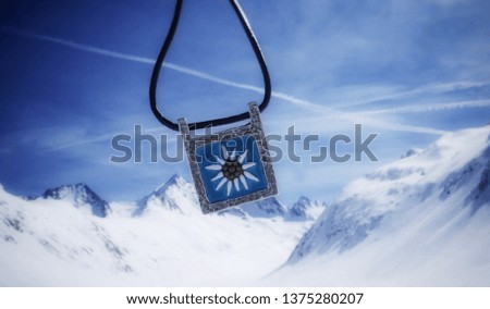Pendant with edelweiss in the high mountains in the Alps