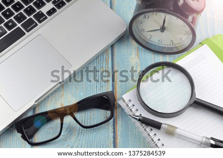 Flat lay business workplace and objects on wooden background. Top view. Selective focus.