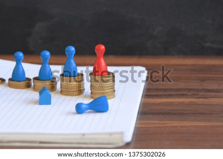 On a wooden background coins were stacked, which together form an ascending curve, on each of the heaps is a character. The figure with the highest value has a different color