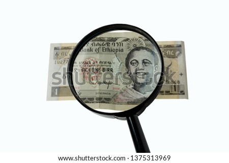 one Ethiopian birr bill and magnifying glass isolated on white background, obverse front side