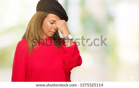 Middle age adult woman wearing fashion beret over isolated background tired rubbing nose and eyes feeling fatigue and headache. Stress and frustration concept.