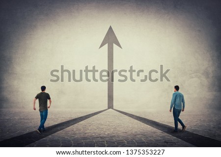 Two men walking on a pavement road and pathways join together and transform into a straight arrow going up. Business cooperation and partnership, sharing thoughts, working and merge for common goal. Royalty-Free Stock Photo #1375353227