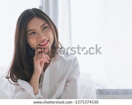 Closeup portrait of attractive young Asia woman smiling on morning weekend.
