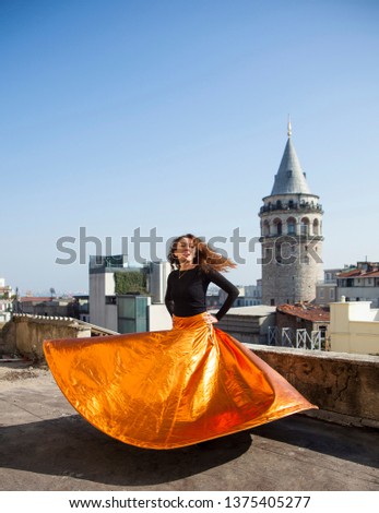 Unidentified whirling woman Dervish or Semazen in Istanbul, Turkey. Galata Tower and city in background - Image